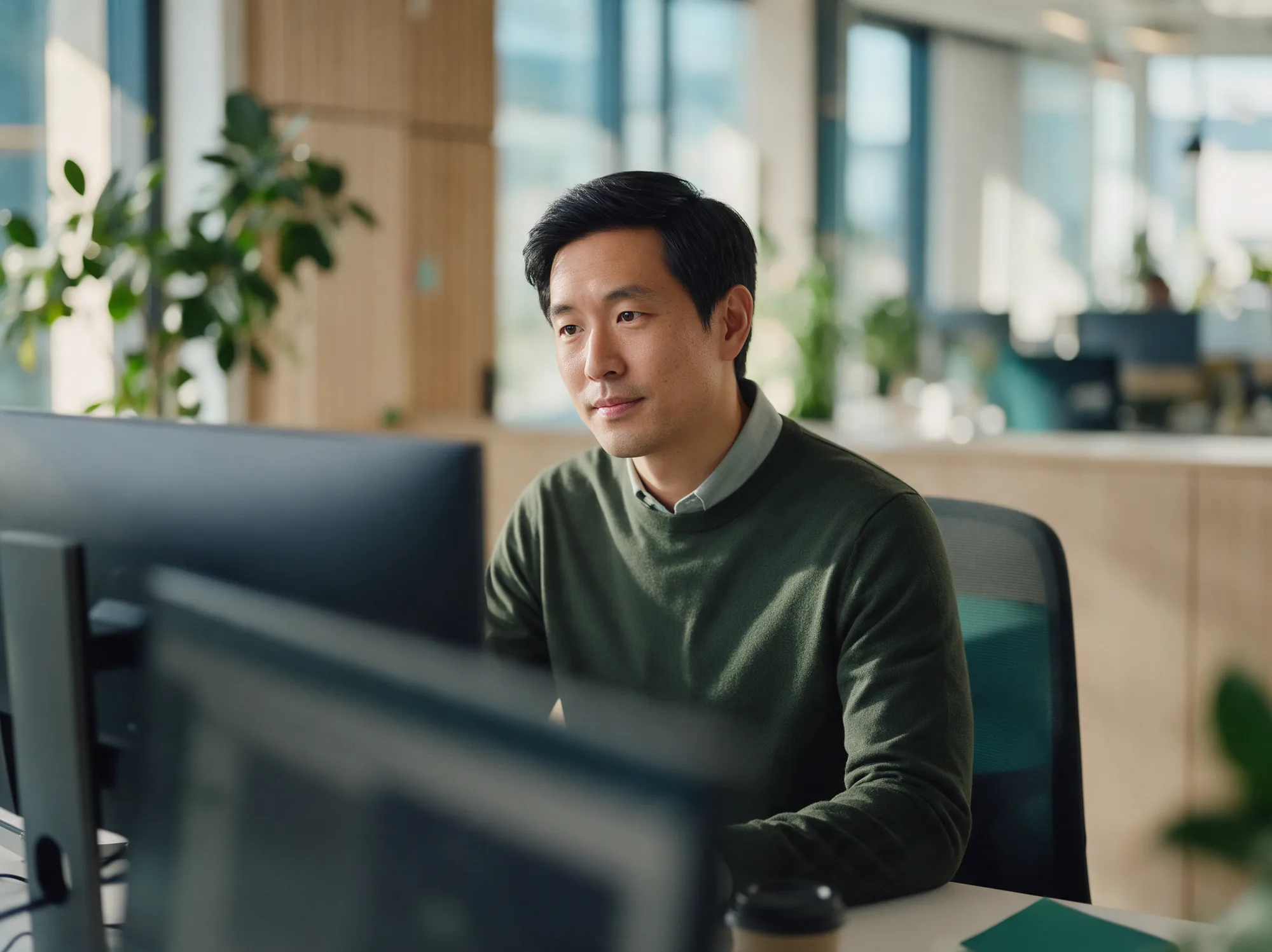 Payments analyst reviewing orders at his desk